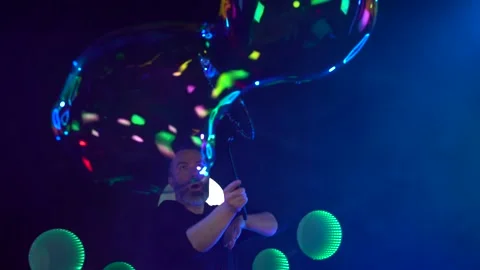 Man in the Studio blows soap bubbles Stock Footage 141708312