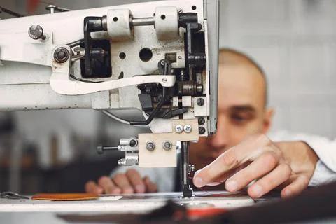 Man in a studio creates leather ware Stock Photos