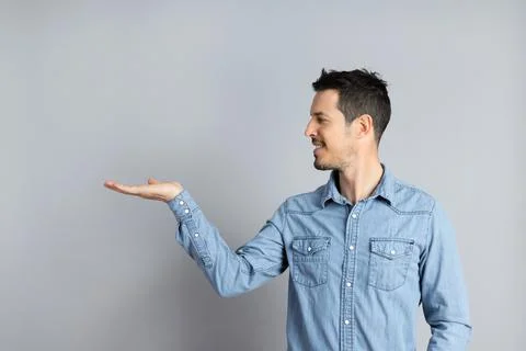 Man in studio showing something with hand, showing your text, holding copy-space Stock Photos