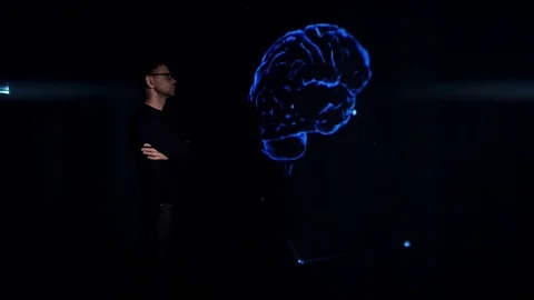 The man is studying the 3d model of the human brain. Stock Footage 77676633