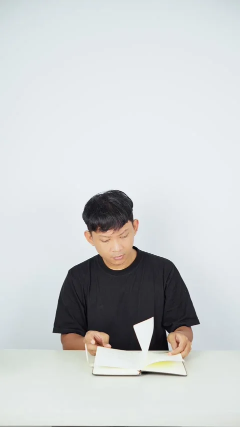 Man Studying and Writing in Notebook on White Background Stock-Footage 347105462