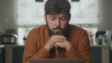 Man studying on a computer laptop Stockbeeldmateriaal 199490213