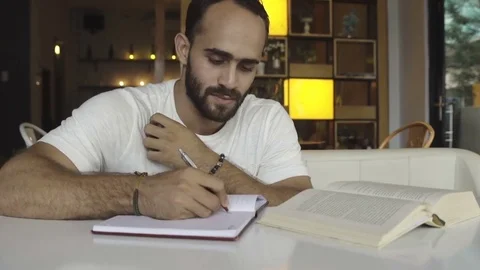 Man studying, doing homework, preparing for test Stock Footage 83766340