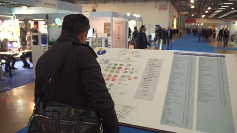 Man studying floor plan of a fair pavilion  Stock Footage 106496191
