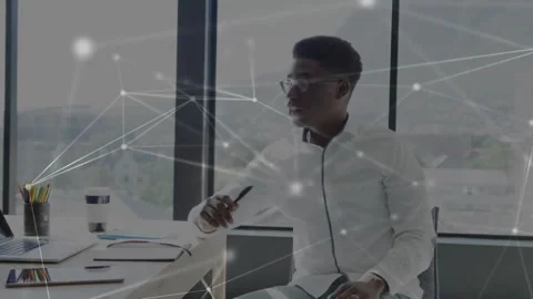 Man studying laptop and notes analyzing tech data gesturing pen while network Stock Footage 330980921