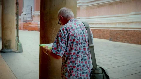 Man Studying Map Beneath Bologna Porticoes Stock Footage 327346077