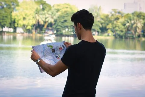 Man Studying Map by the Lake Stock Photos