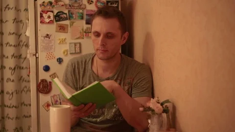 The man is studying notes in a notebook Stockbeeldmateriaal 82186019