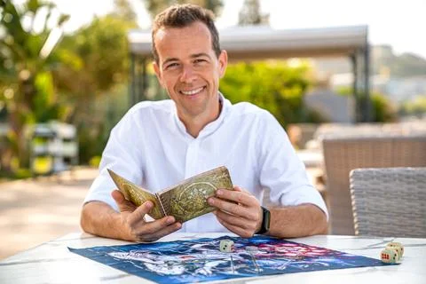Man Studying Rules for Board Game of Leela. Portrait of Man Holding Book in.. Stock Photos