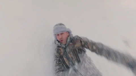 The man stumbles and tumbles down the snow from a high hill. Stock Footage 327716974