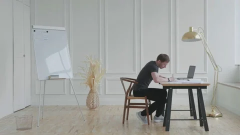 A man in a stylish loft works with documents. Stock Footage 131270992