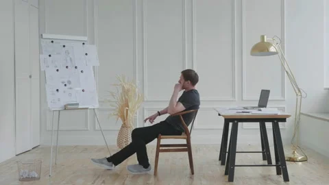 A man in a stylish loft works with documents. Stock Footage 131272308