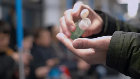 Man in subway applying sanitizer Stock Footage 126863987