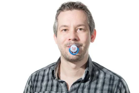 A man sucking on a pacifier Stock Photos