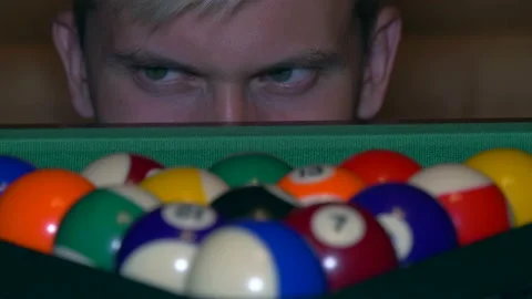 Man suddenly appears from the billiard's table and looks angry on balls. Stock Footage 204942760