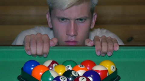 Man suddenly appears from the table and moves billiard balls. Stock Footage 204942621