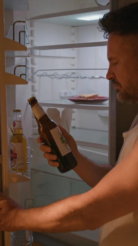 Man Suffering from Alcohol Addiction Taking Beer from Refrigerator Stock Footage 344853764
