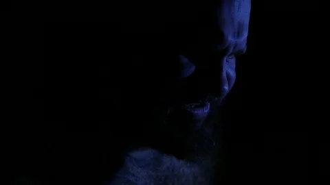 Man suffering and screaming in darkness. 4K UHD Stock Footage 73677413