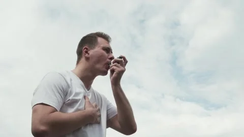 Man suffering from an asthma attack and using asthma inhaler Video stock 242419983