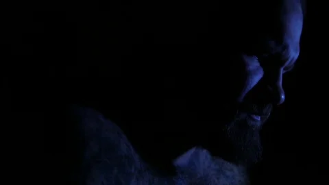 Man suffering breathing deeply scared in darkness. 4K UHD Stock Footage 73677285