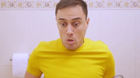 Man suffering from diarrhea using toilet paper in bathroom. Funny Stock Footage 309432829