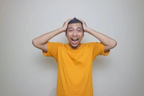 Man suffering from headache or thinking over white background Stock Photos