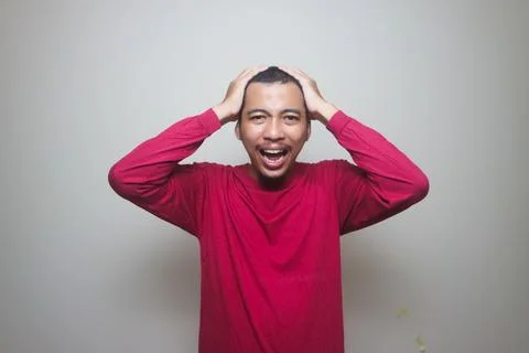 Man suffering from headache or thinking over white background Stock Photos