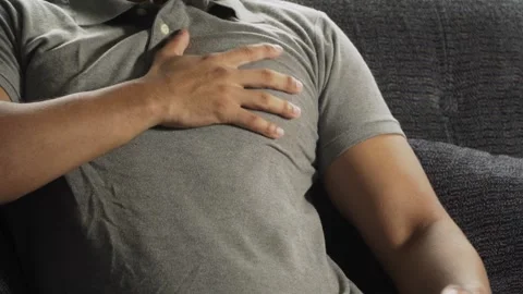 Man suffering heart attack on sofa Video stock 317056292