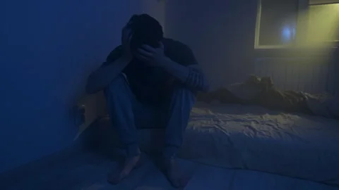 Man suffering from insomnia sitting on bed at night, stressed and exhausted Stock Footage 320187669