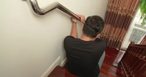 Man suffering from low back and leg pain while going down the stairs. Stock Footage 276950661