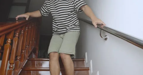 Man suffering from low back pain while walking down the stairs. Stock Footage 238930803