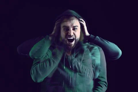 Man suffering from paranoia on dark background. Multiple exposure with phot.. Stockfoto's