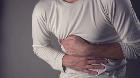 Man suffering from stomach ache, holding his belly and having painful cramps. Stock Footage 59242225