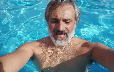 Man suffering in swimming pool Stock Photos