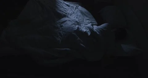 Man suffers from insomnia and cannot sleep Stock Footage 166499360