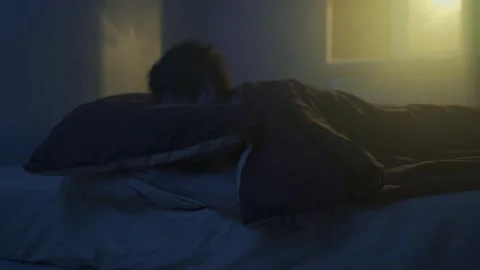Man suffers from insomnia, lying awake at night, dark bedroom Video stock 320175455