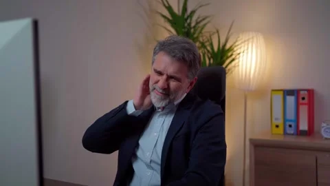 Man suffers from neck pain while working in the office Stock Footage 268328290