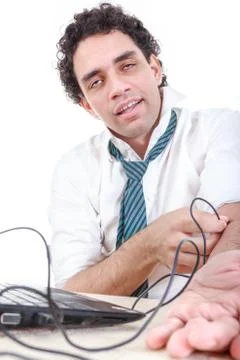Man in suit addicted to internet put usb cable from laptop computer into his  Stock Photos