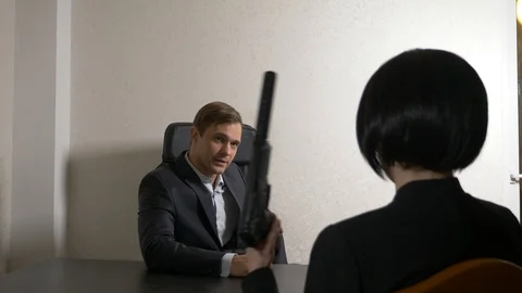 A man in a suit asks questions to a brunette woman in an interview Stock Footage 88387067