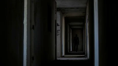 A man in a suit with a baseball bat in the building Stock Footage 75945357