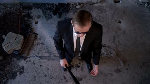 A man in a suit with a baseball bat in the building Stock Footage 75954667