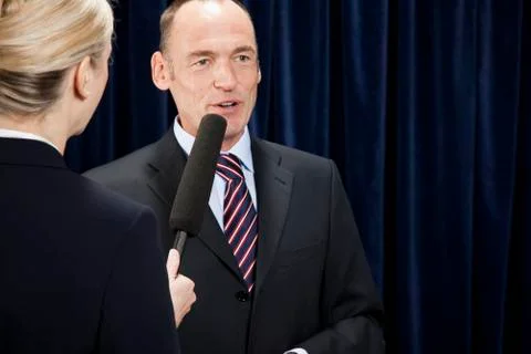 A man in a suit being interviewed Stock Photos