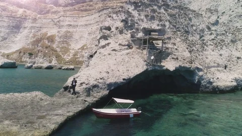 Man in suit with briefcase walking down stone steps while talking on his Stock Footage 77897012