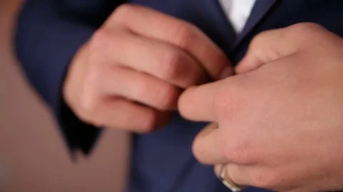 Man in suit buttoning his jacket Stock Footage 80674930