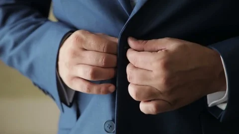 Man in suit buttoning his jacket Stock Footage 82528321