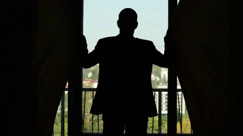 Man in suit come to window and close curtains, slow motion shot Video stock 80741560
