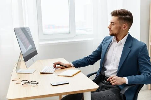 A man in a suit computer desktop work self-confidence paper folder executive Stock Photos