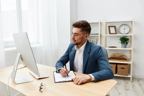 A man in a suit computer desktop work self-confidence paper folder Gray Stock Photos