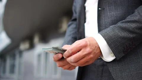 Man in suit counting dollar bills. Stock Footage 134457062