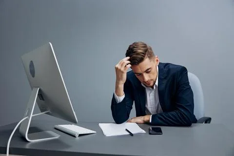 A man in a suit emotions problems with documents on the table technologies 스톡 사진